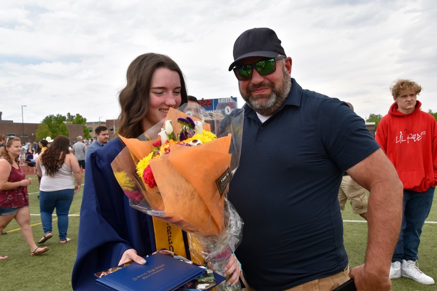 Dad Trent John was giving his daughter Taylor flowers.